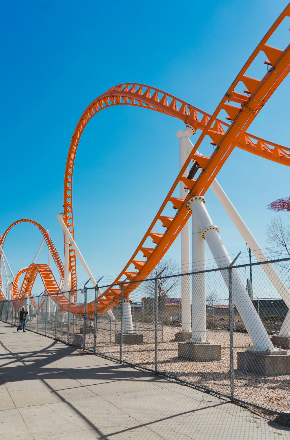 close-up photography of white and orange roller coaster during daytime