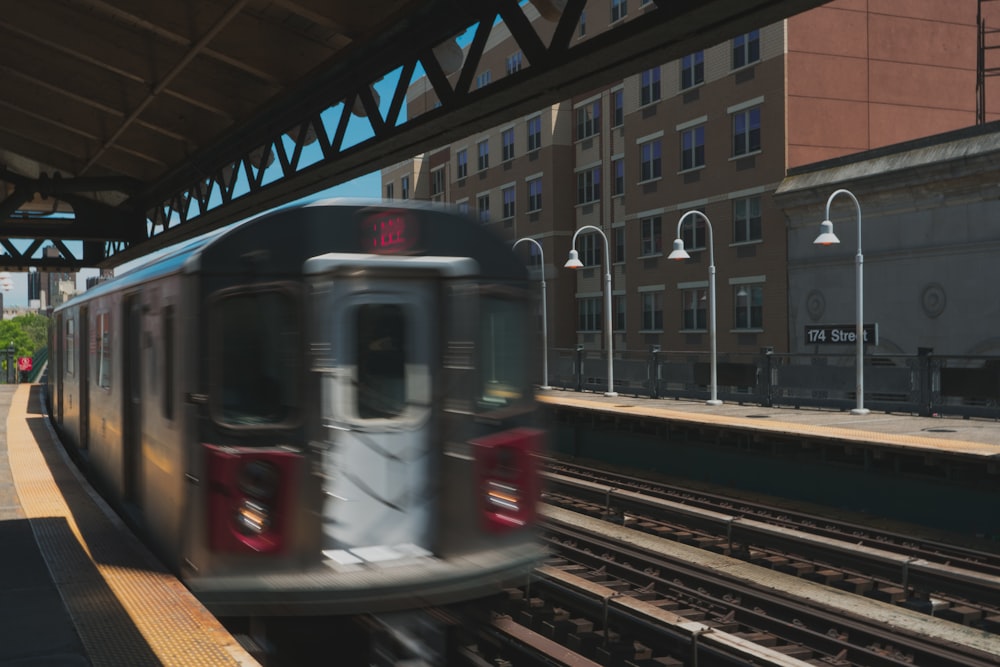 train running in a railway during daytime