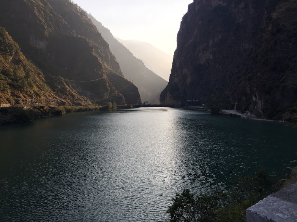 body of water across brown mountains