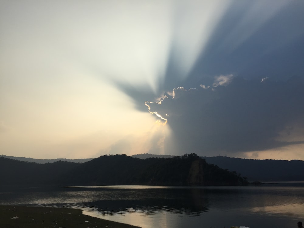 body of water under white clouds