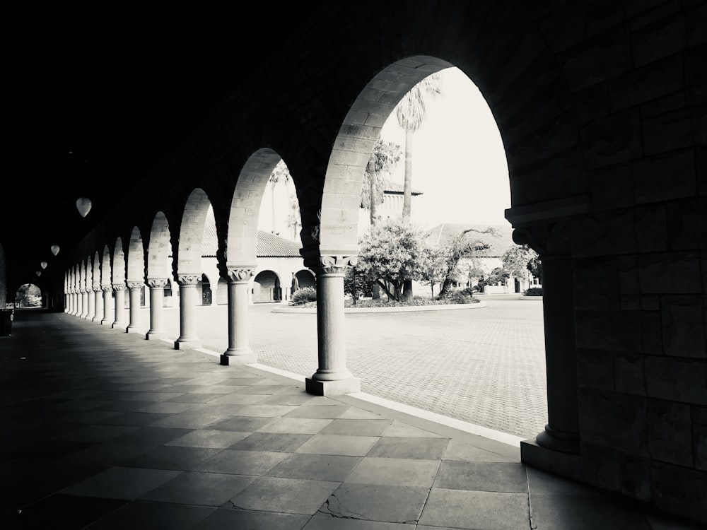 a black and white photo of an arched walkway