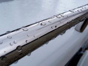 a close up of a car with water drops on it