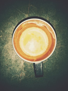 Side view of a functional ceramic mug with a warm earth-toned glaze.