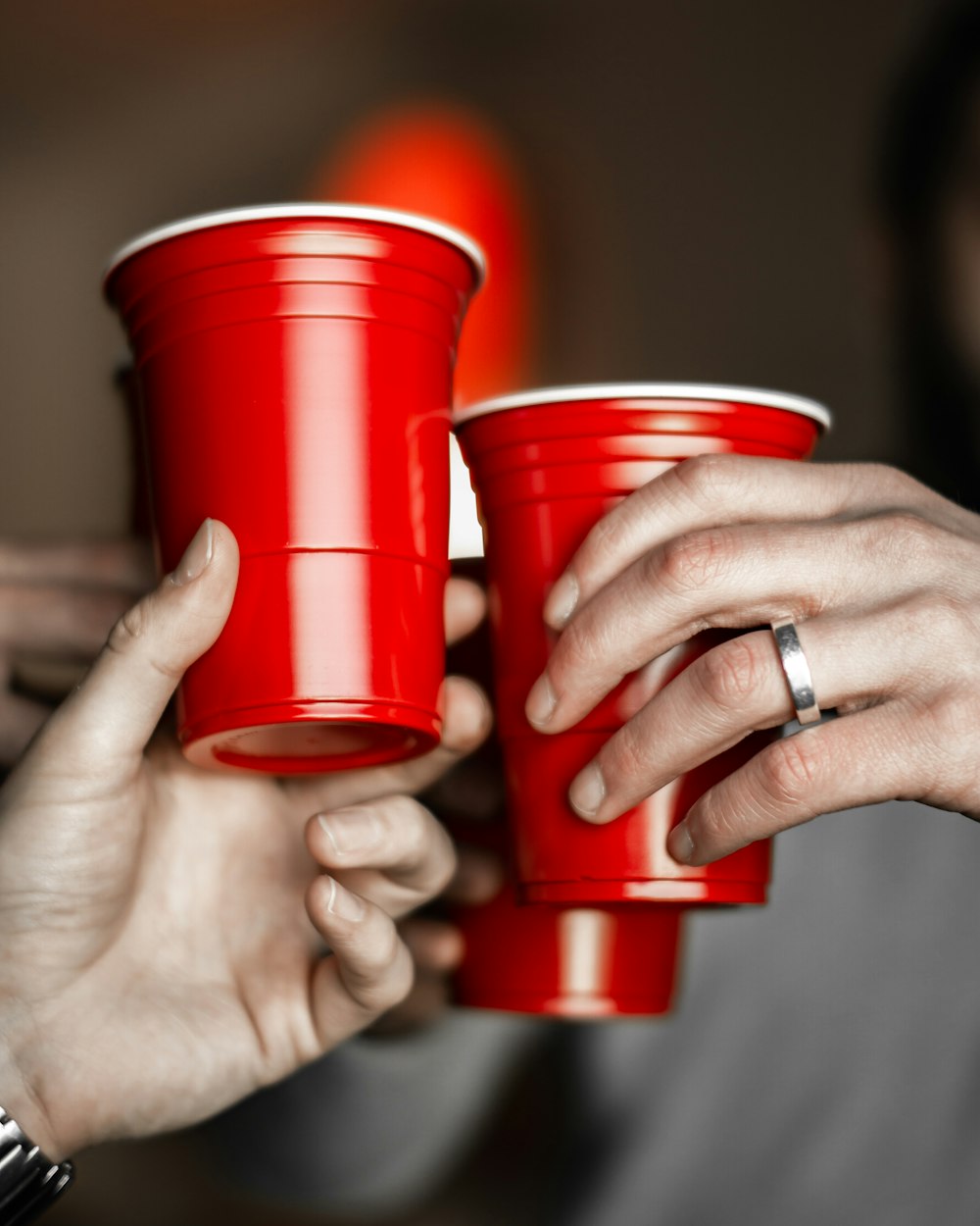 person holding red solo cups
