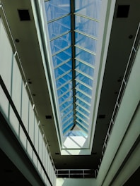A bright interior room illuminated by a large, custom polycarbonate skylight with smooth, precise framing.