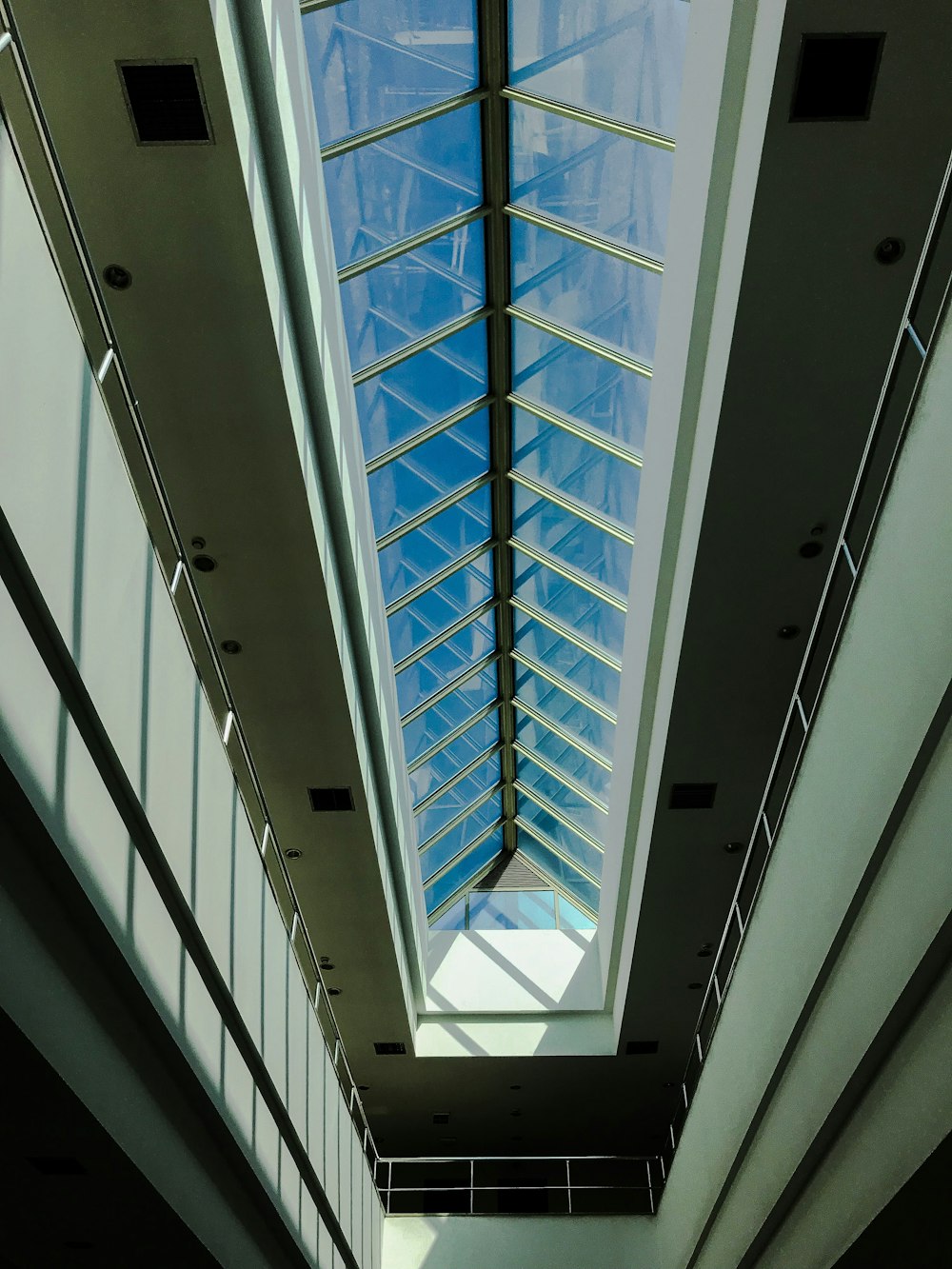 white concrete building interior with glass ceiling