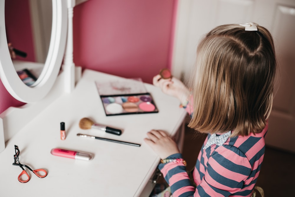 girl sitting in front of white table