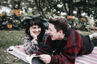 man and woman lying on textile on ground during daytime
