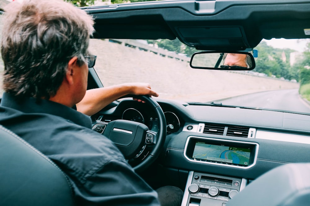 man driving vehicle during daytime