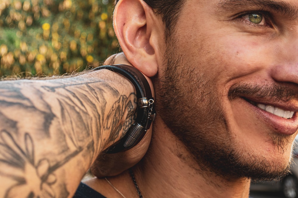 smiling man wearing black watch