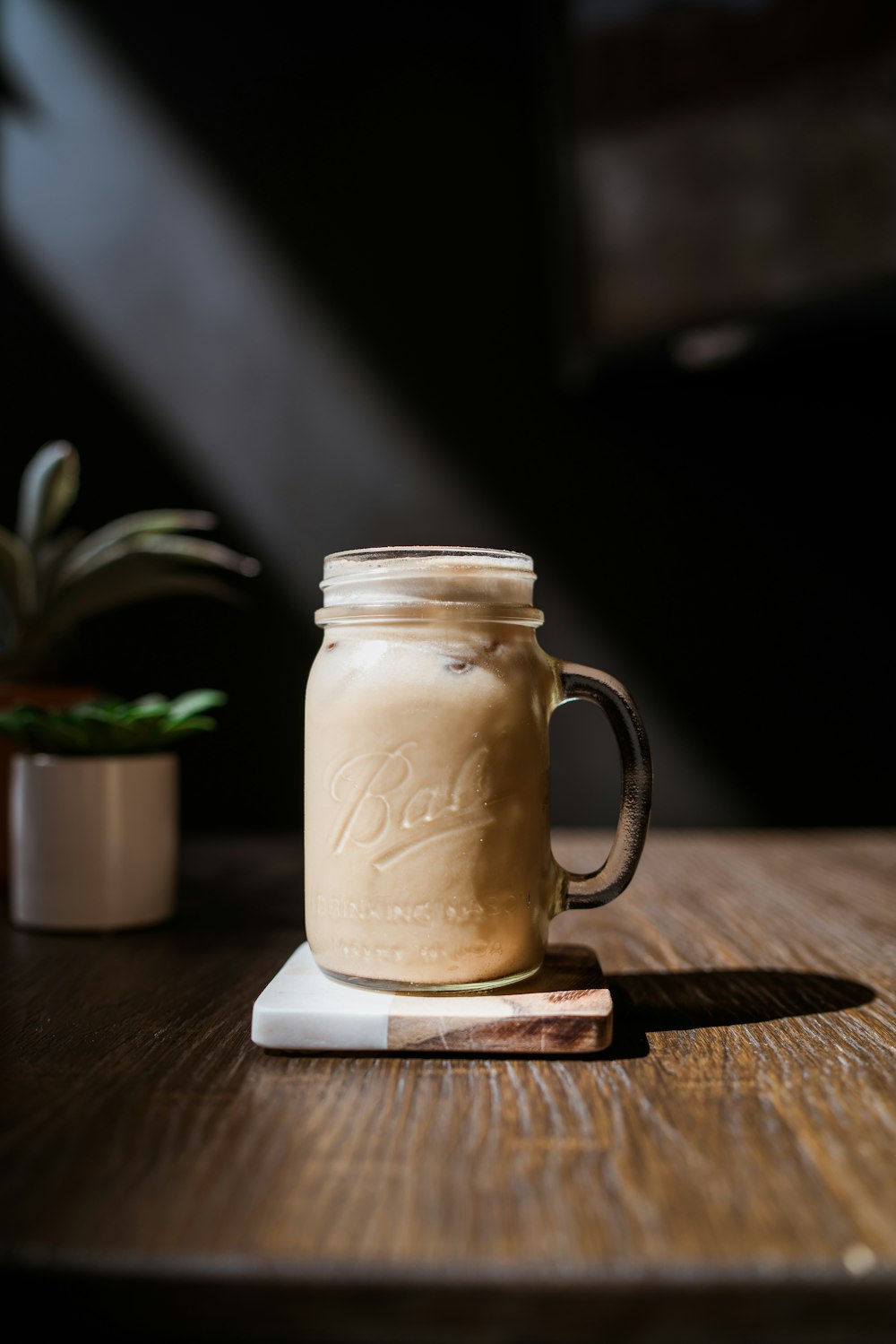 clear glass mug on coaster