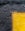 water droplets falling to yellow paint on gray surface