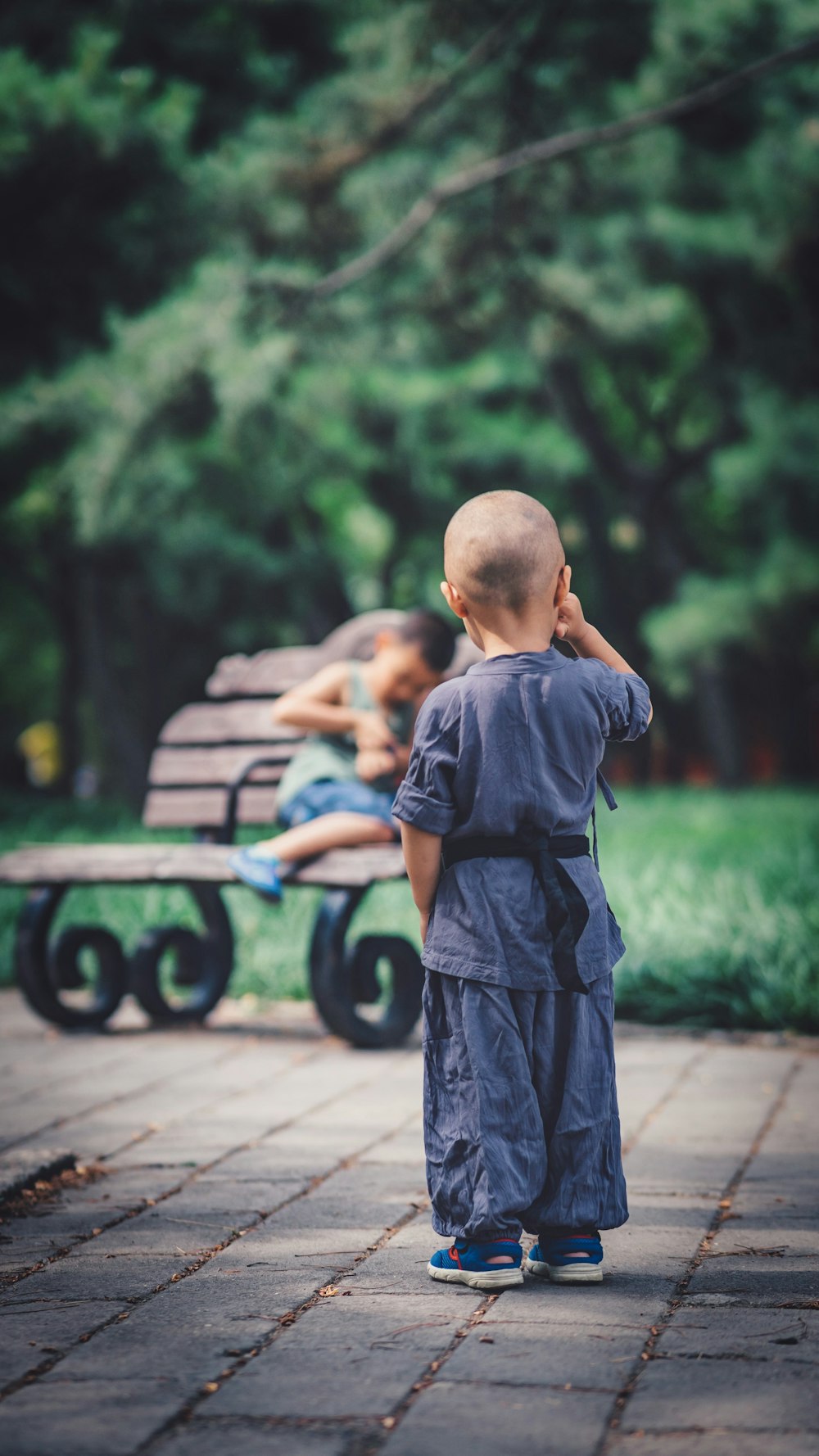 boy standing near bench