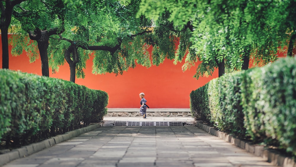 boy standing near trees