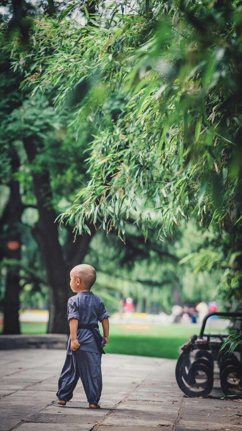 boy standing near empty benc