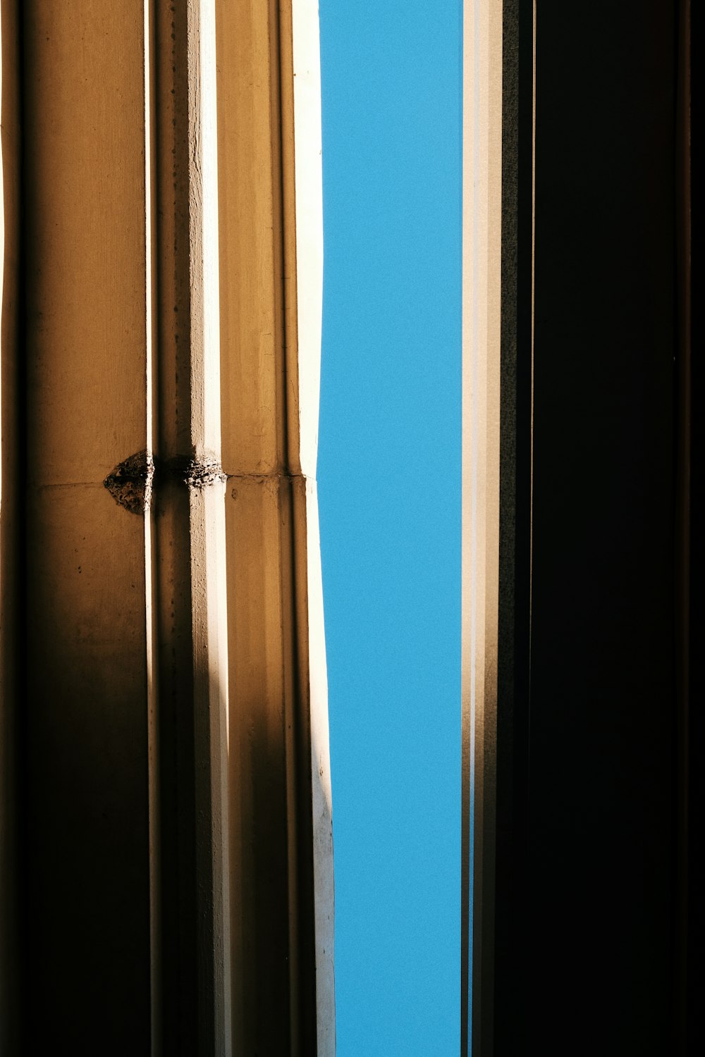 a window with a blue sky in the background