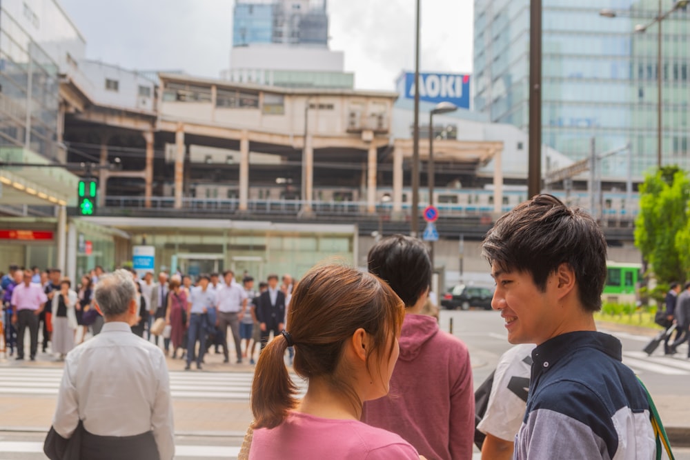 people standing beside road during daytime