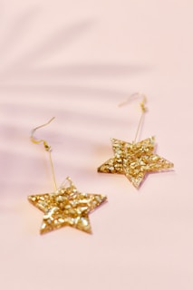 pair of gold-colored star earrings