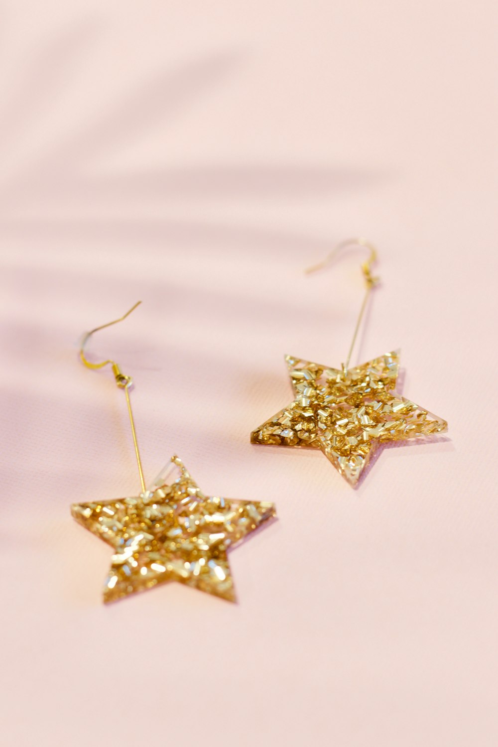 pair of gold-colored star earrings