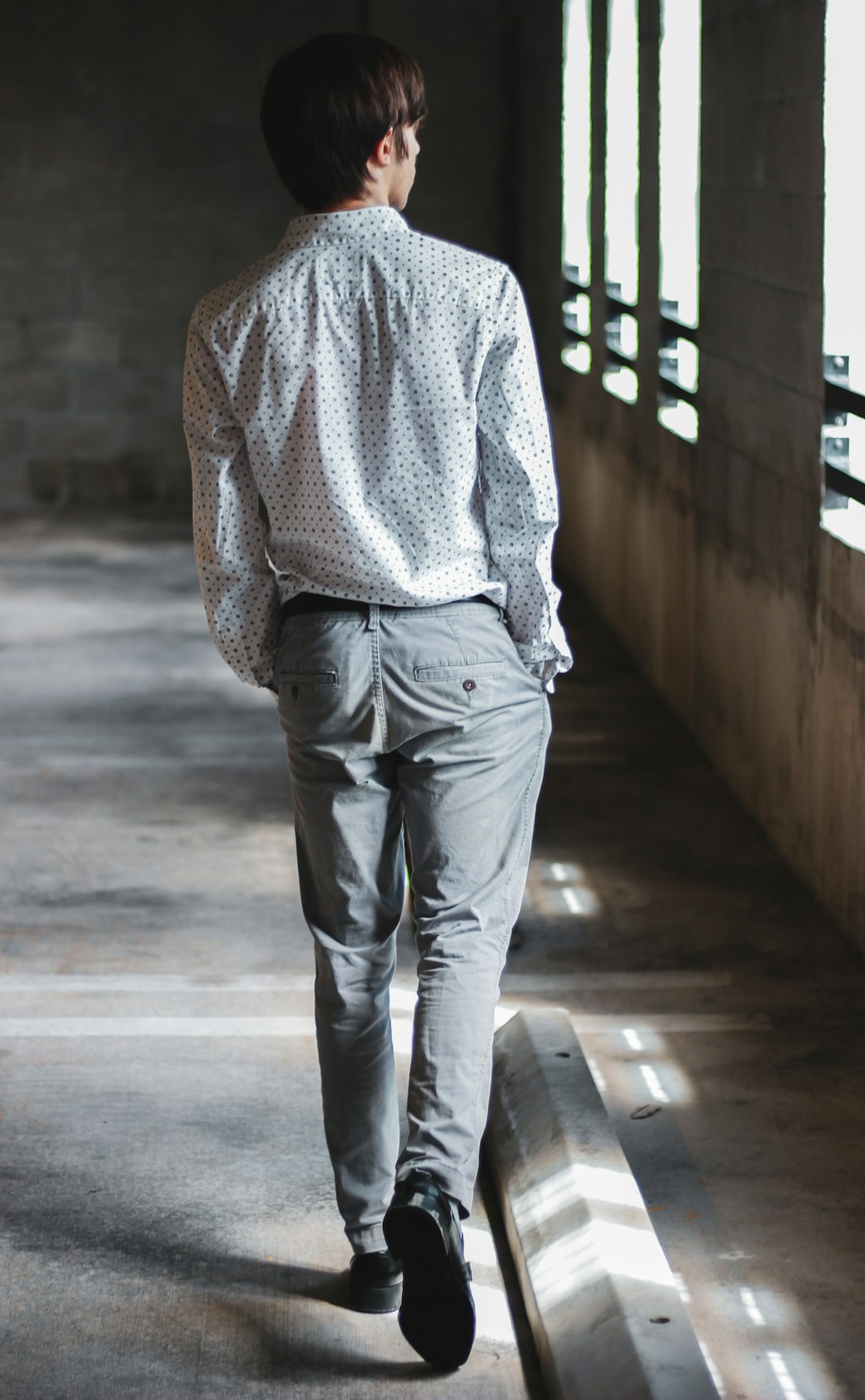 man walking beside window