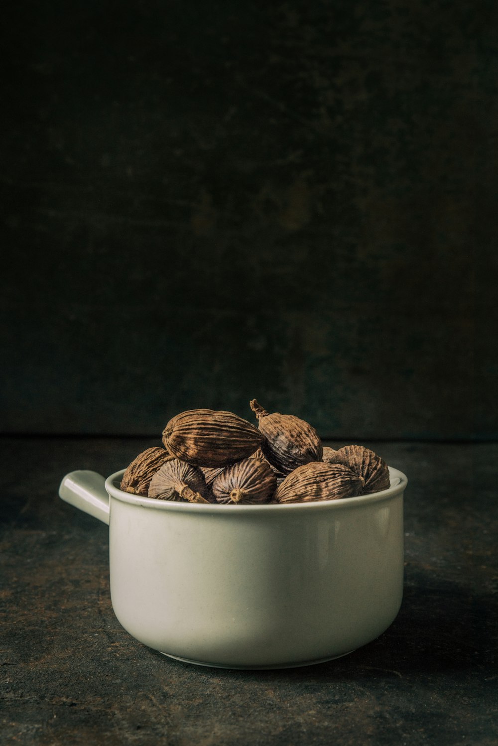 brown seeds on white bowl