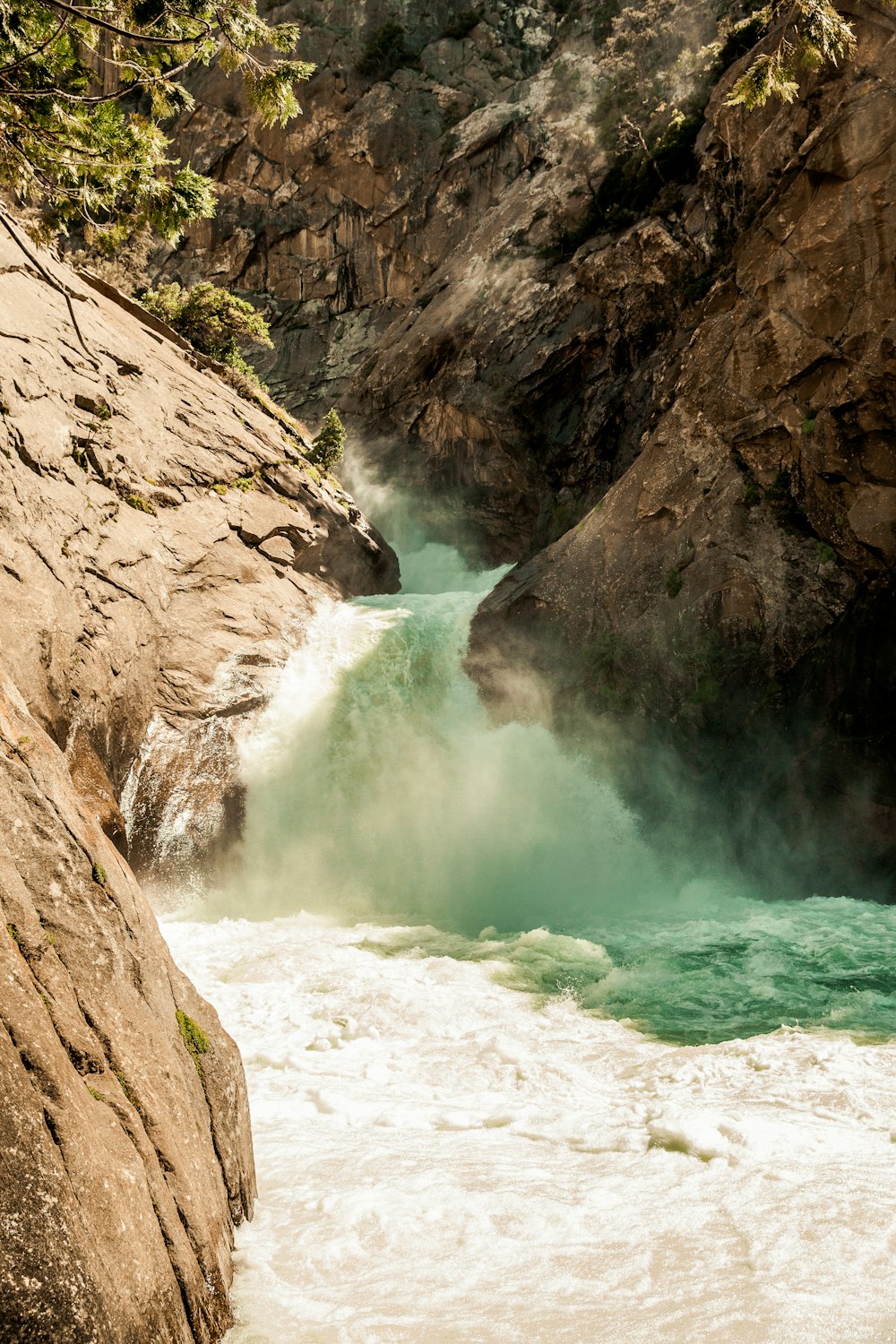 flowing water beside rock formation