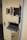 A yellow door with multiple small compartments and latches, featuring a sliding tray mechanism presumably for secure transactions or communications.