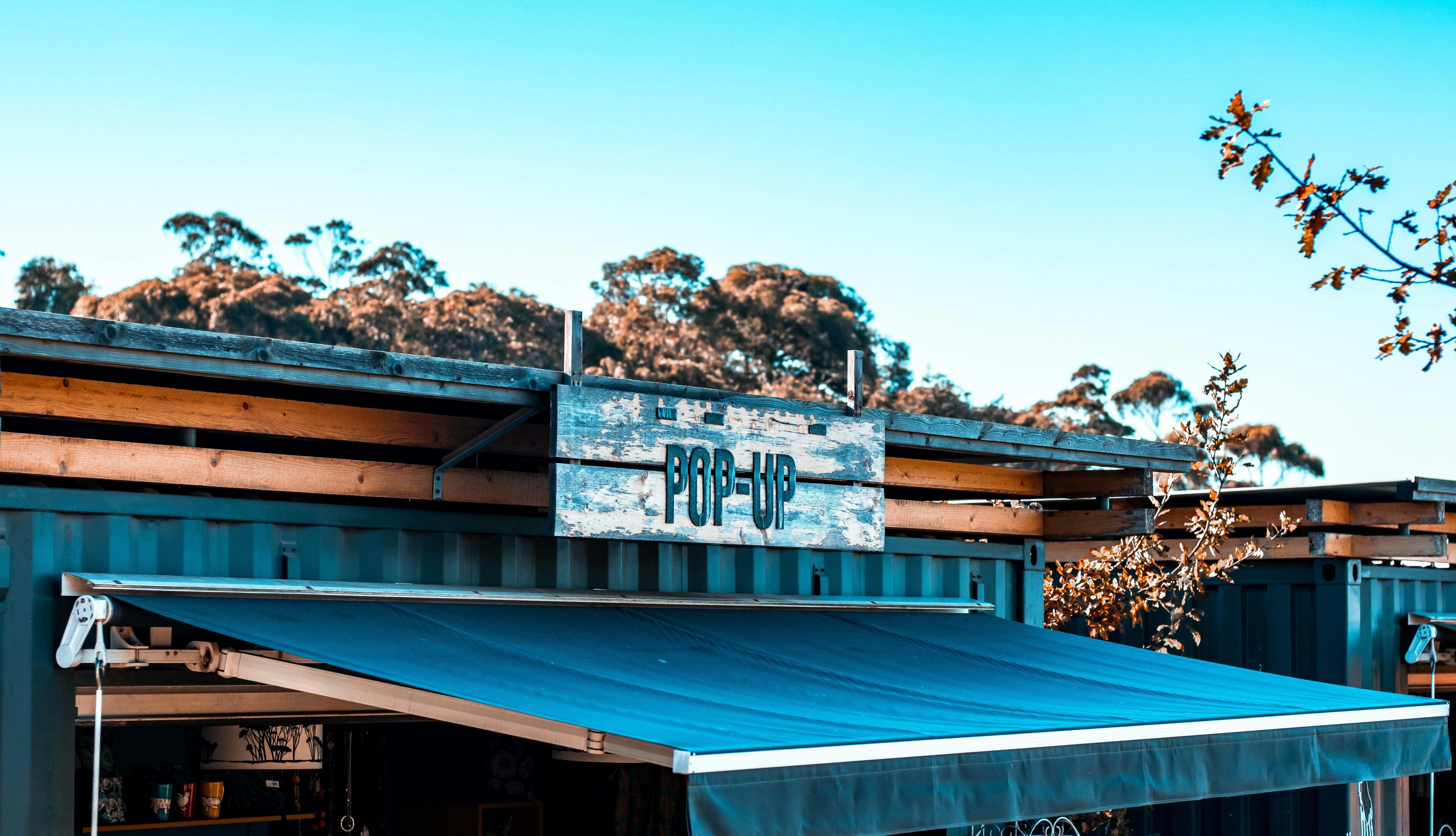 Blue timber pop-up shop with an awning