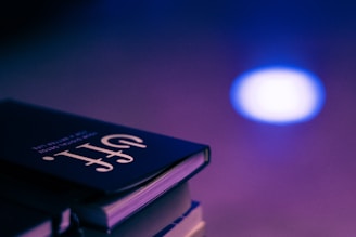 A vibrant stack of colorful eBooks with a glowing digital background