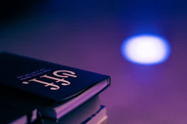 Stack of colorful e-books with a dark blue background reflecting the brand colors.