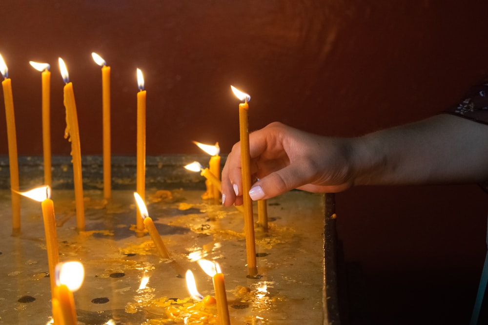 person holding yellow candle