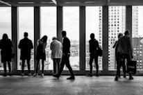 people standing in building grayscale photography