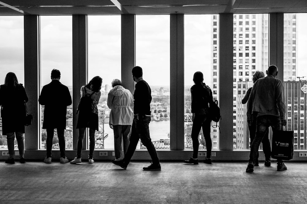 people standing in building grayscale photography