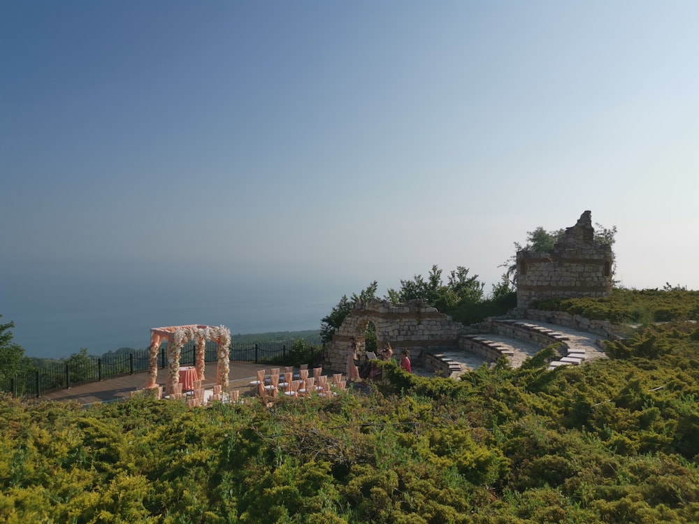 an outdoor ceremony set up on top of a hill