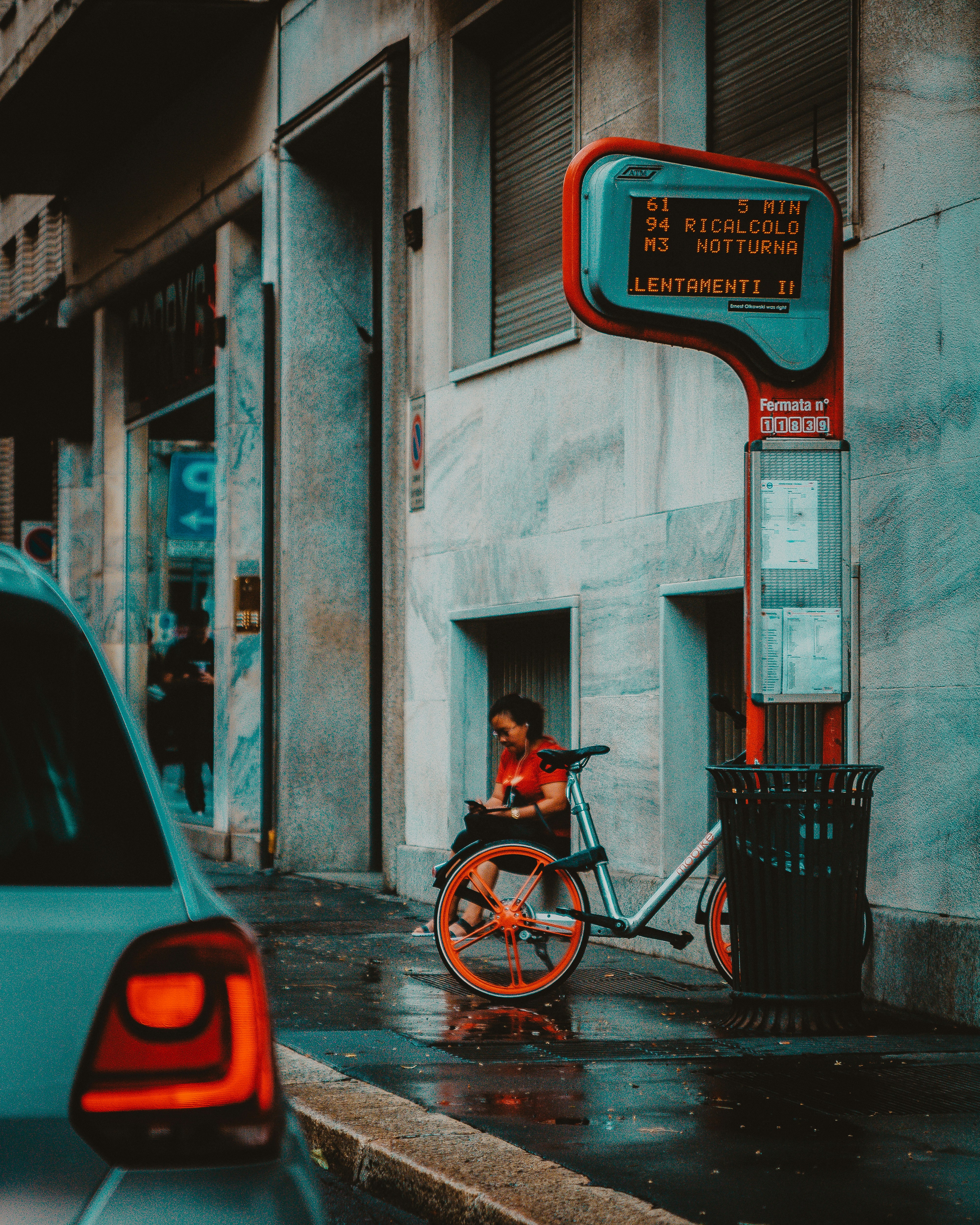 gray bicycle parked near vehicle