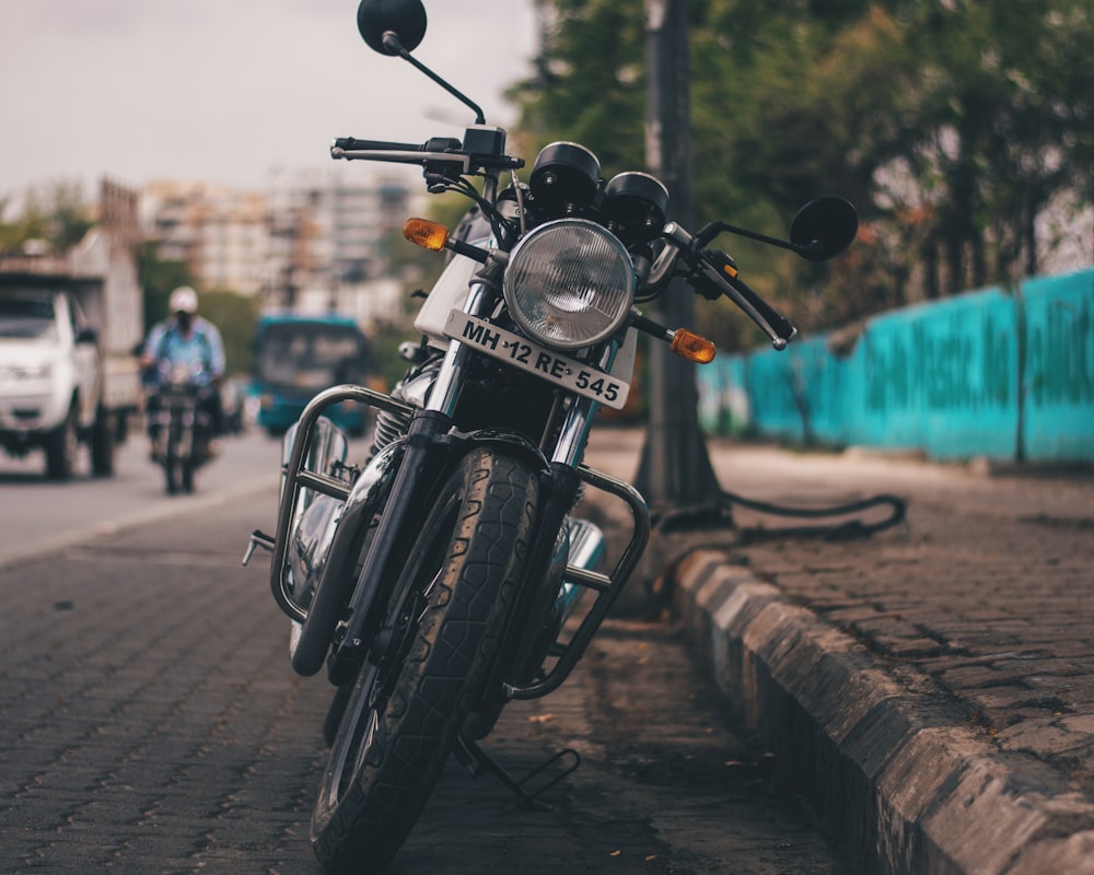 black motorcycle beside road