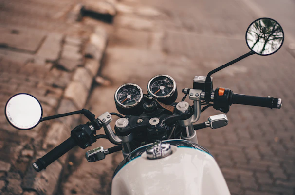 Close-up of a motorcycle's dashboard and handlebars, showing well-maintained controls and gauges.