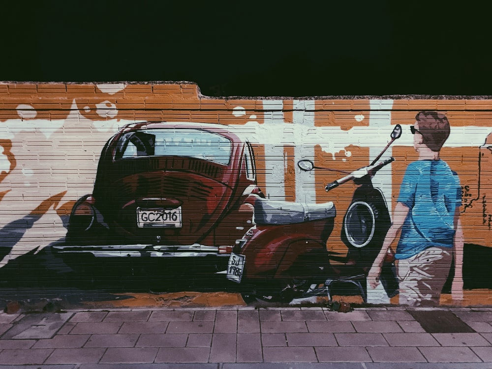 man standing beside motor scooter wall paint