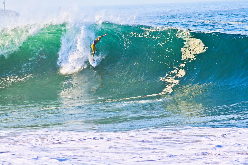 person riding on surfboard during daytime