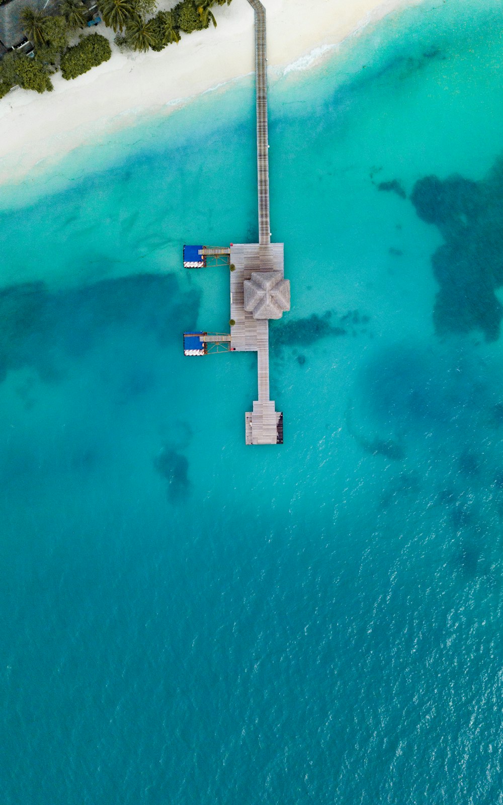 aerial view of dock with white sand