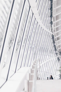 Modern living room with large windows and natural light showcasing sleek architectural design.