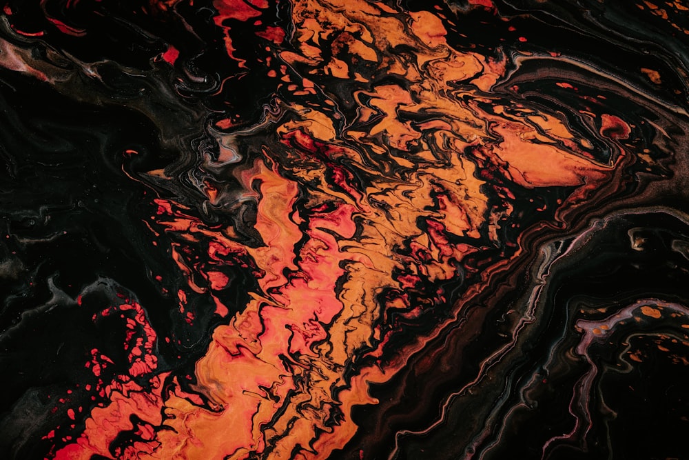 orange and black fluid abstract painting