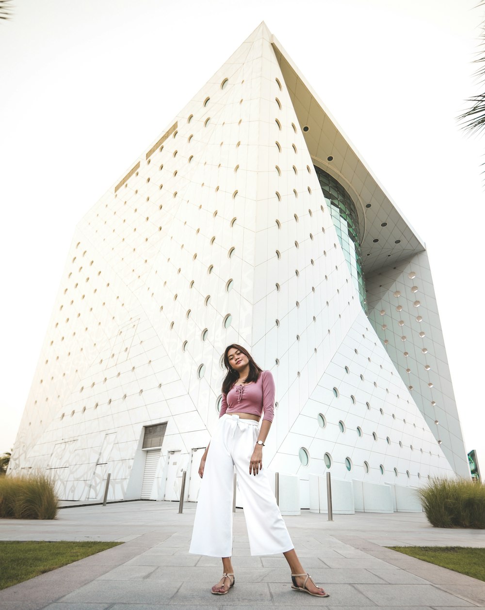 woman standing near white concrete building