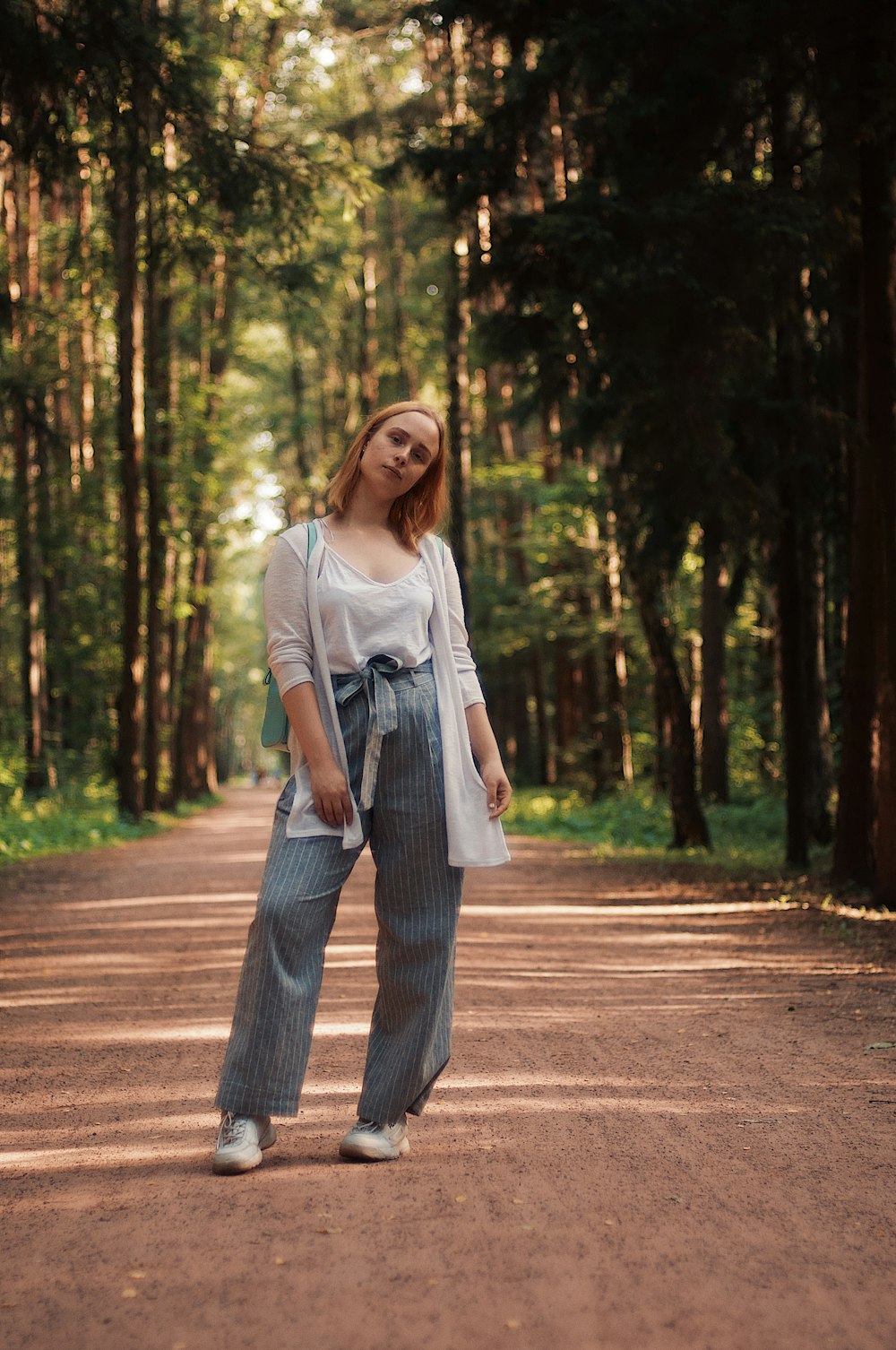 woman standing on dirt road