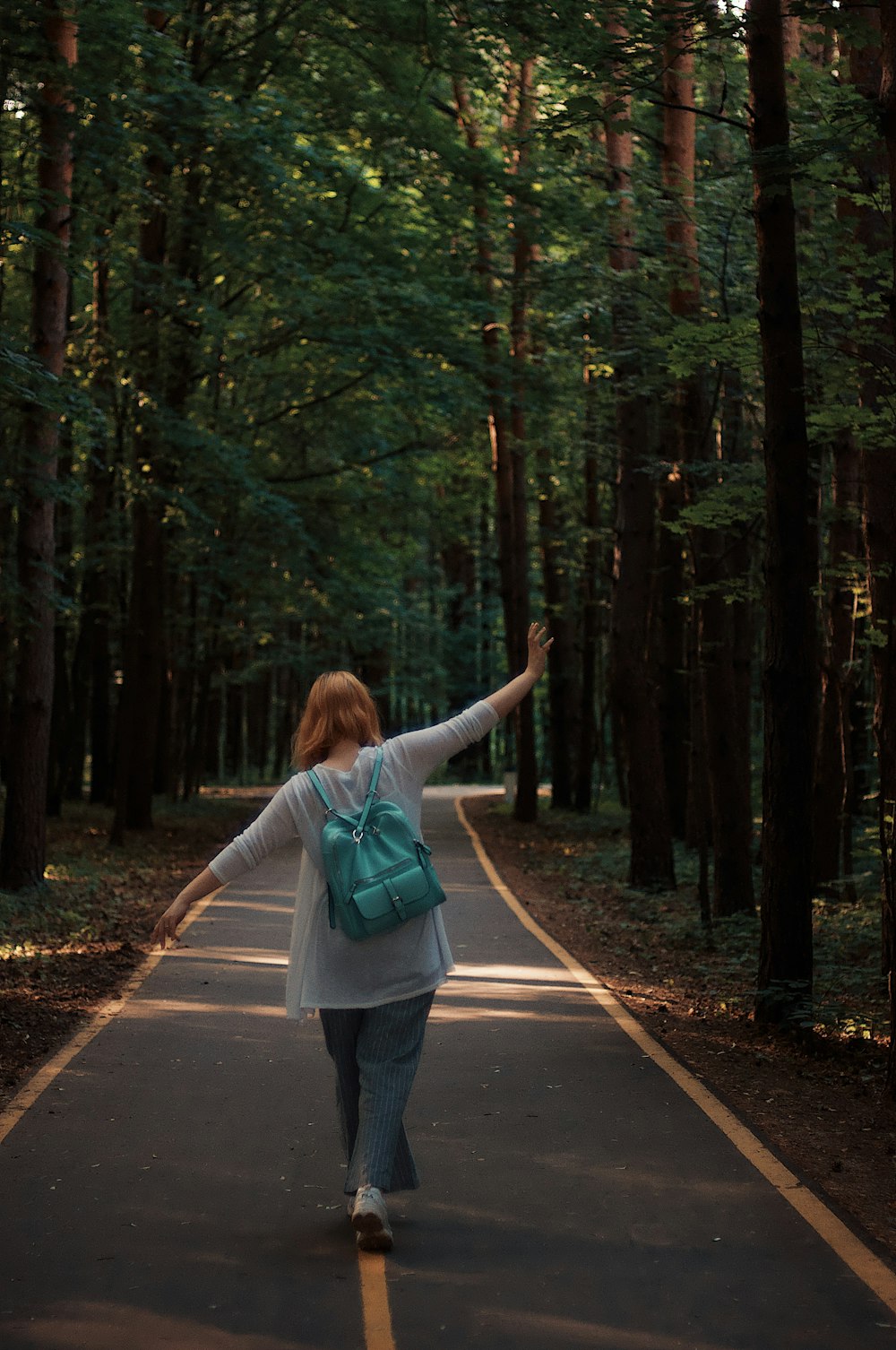 woman walking near trees