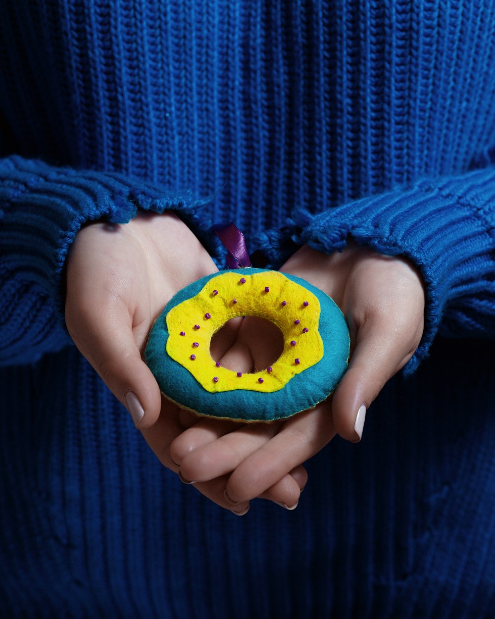 person holding dough not plush toy