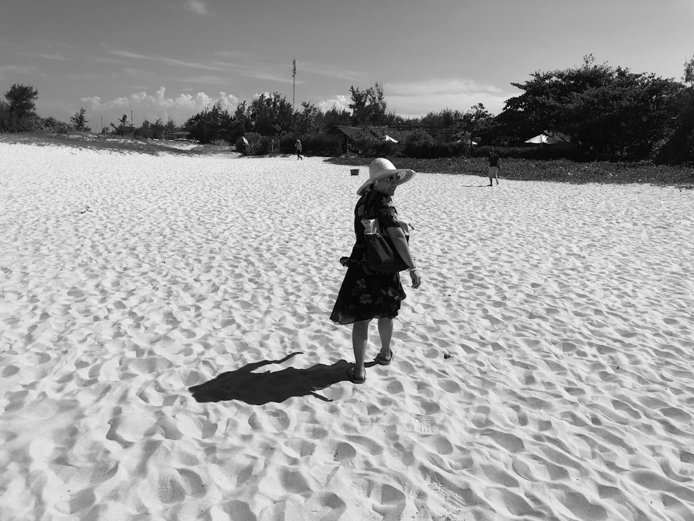 women wearing a summer hat in a sandy land grey-scale photography