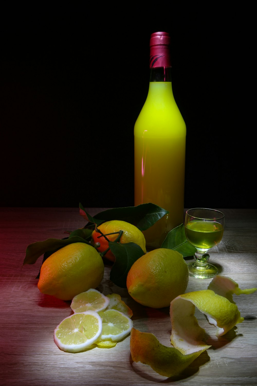 sliced lemon beside glass bottle