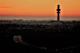 A city skyline at dusk with glowing network towers and signals.
