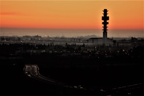 A city skyline at dusk with glowing network towers and signals.